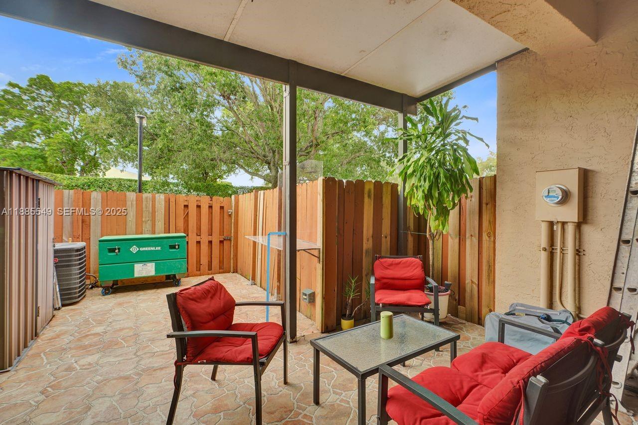 14201 Southwest 57th Lane, Unit 1A7 Miami, FL 33183 - Photo 40 of 48 a backyard of a house with outdoor seating