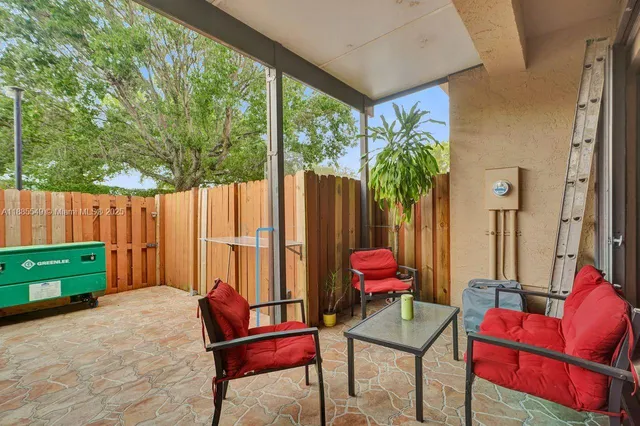 an outdoor sitting area with furniture and a yard