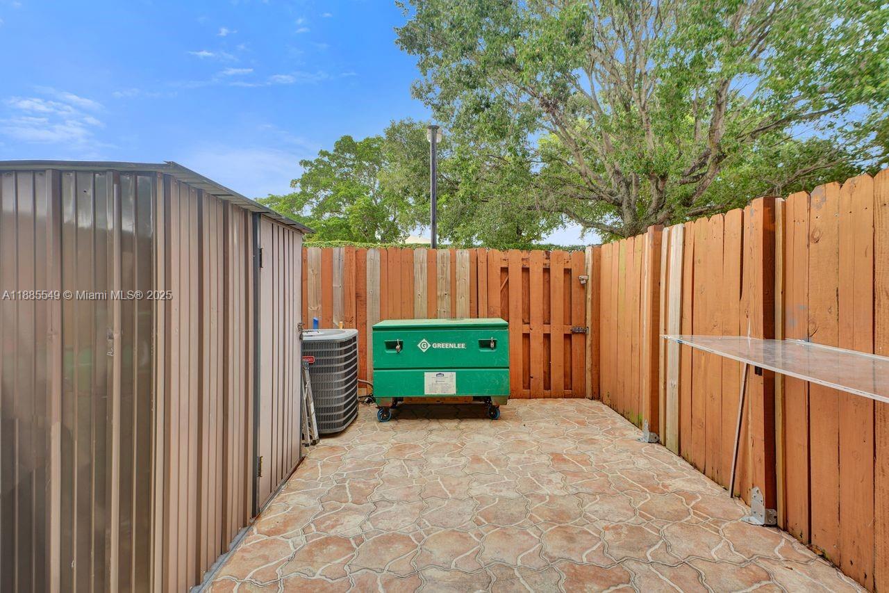 14201 Southwest 57th Lane, Unit 1A7 Miami, FL 33183 - Photo 42 of 48 a view of outdoor space with wooden fence