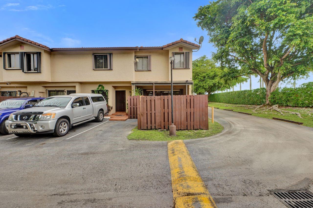 14201 Southwest 57th Lane, Unit 1A7 Miami, FL 33183 - Photo 47 of 48 a view of a car parked in front of a house