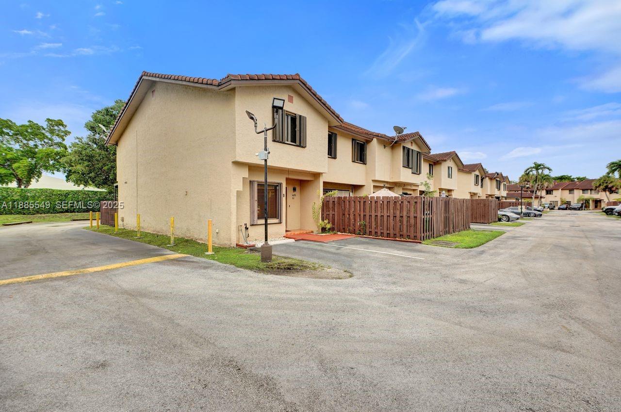 14201 Southwest 57th Lane, Unit 1A7 Miami, FL 33183 - Photo 6 of 48 a front view of a house with a yard