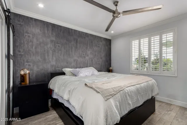 a bedroom with a bed and a mirror on dresser