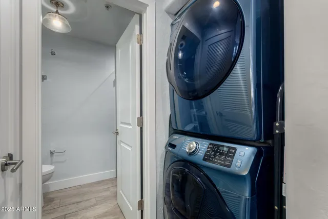 a bedroom with a bed a flat tv screen and a large window