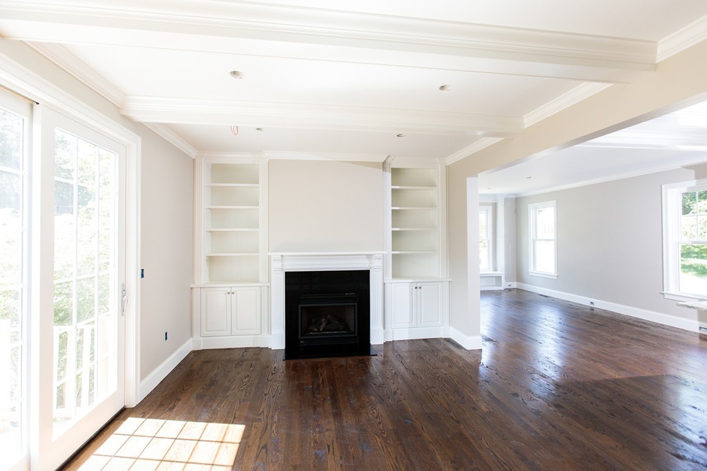 9 Ridgeway Avenue Needham, MA 02492 - Photo 9 of 19 a view of empty room with wooden floor and fireplace