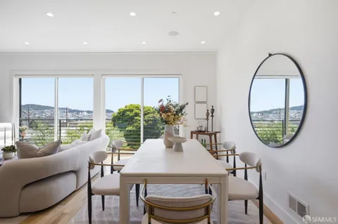 a living room with furniture and a painting