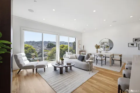 a living room with furniture fireplace and potted plants