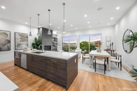 a kitchen with stainless steel appliances granite countertop a kitchen island a stove and a wooden cabinets