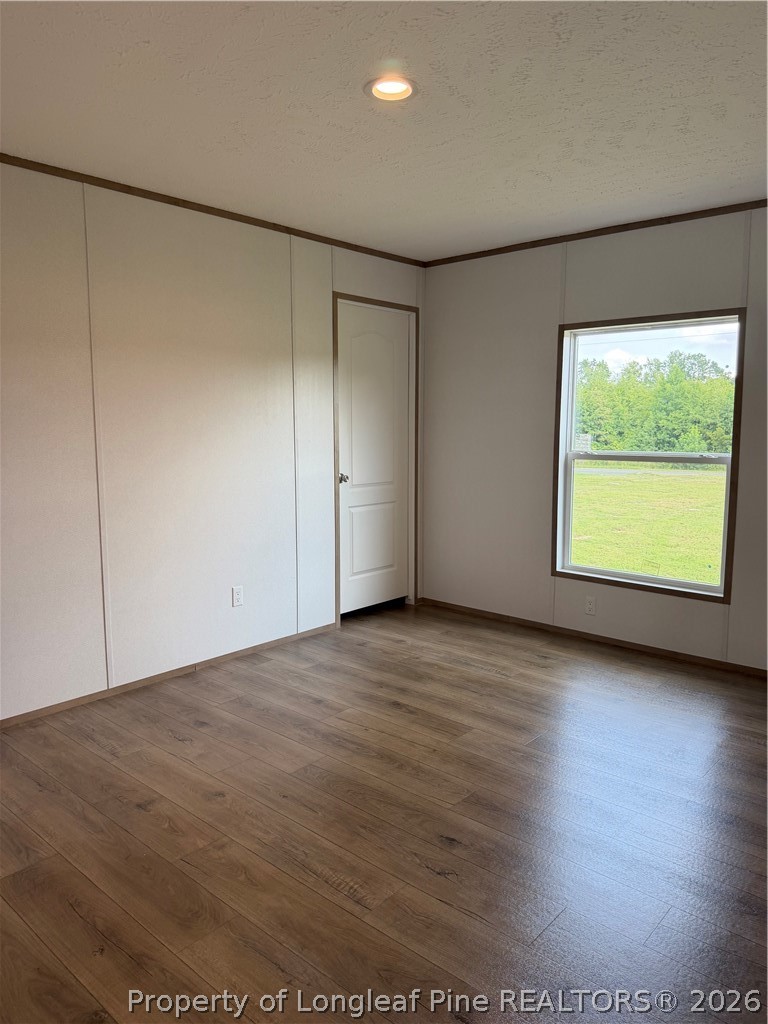 866 Roberta Road Fairmont, NC 28340 - Photo 16 of 16 an empty room with wooden floor and windows
