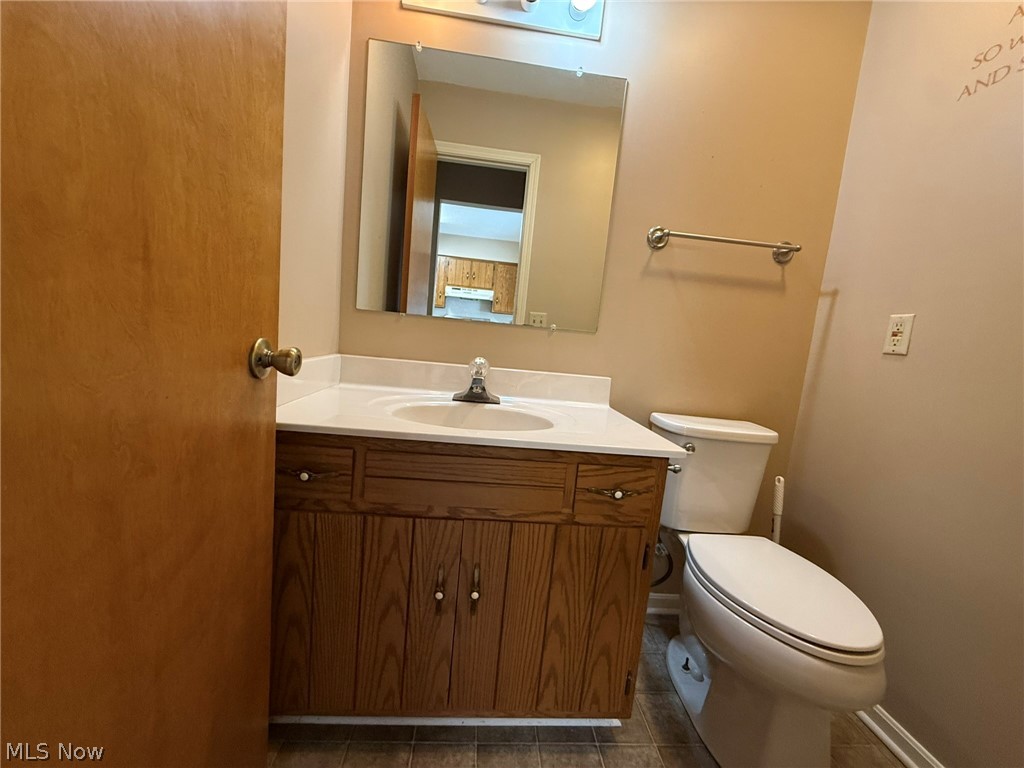 604 Harger Street Dover, OH 44622 - Photo 10 of 25 Bathroom with vanity and dark tile patterned floors