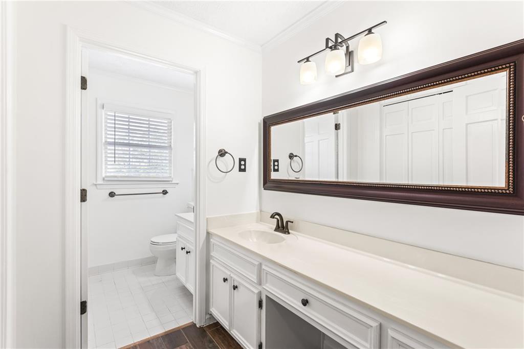 5184 West Price Road Suwanee, GA 30024 - Photo 15 of 25 a bathroom with a sink a toilet and a mirror