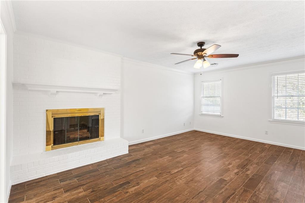 5184 West Price Road Suwanee, GA 30024 - Photo 18 of 25 an empty room with windows and fireplace