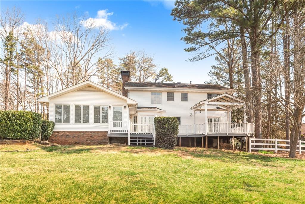 5184 West Price Road Suwanee, GA 30024 - Photo 25 of 25 a front view of a house with a yard table and chairs