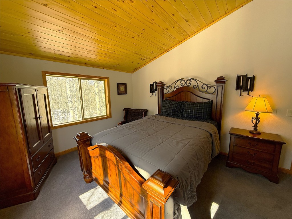1387 High Creek Road Fairplay, CO 80440 - Photo 27 of 47 a bedroom with a bed and dresser with mirror