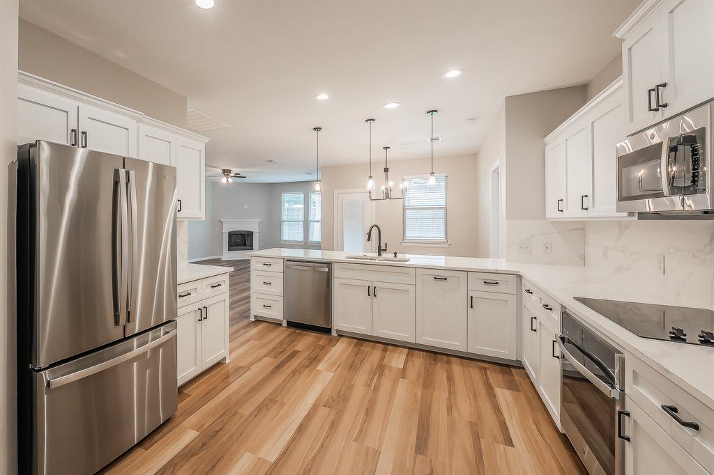 412 Hideaway Road McKinney, TX 75072 - Photo 8 of 40 a kitchen with white cabinets stainless steel appliances and window