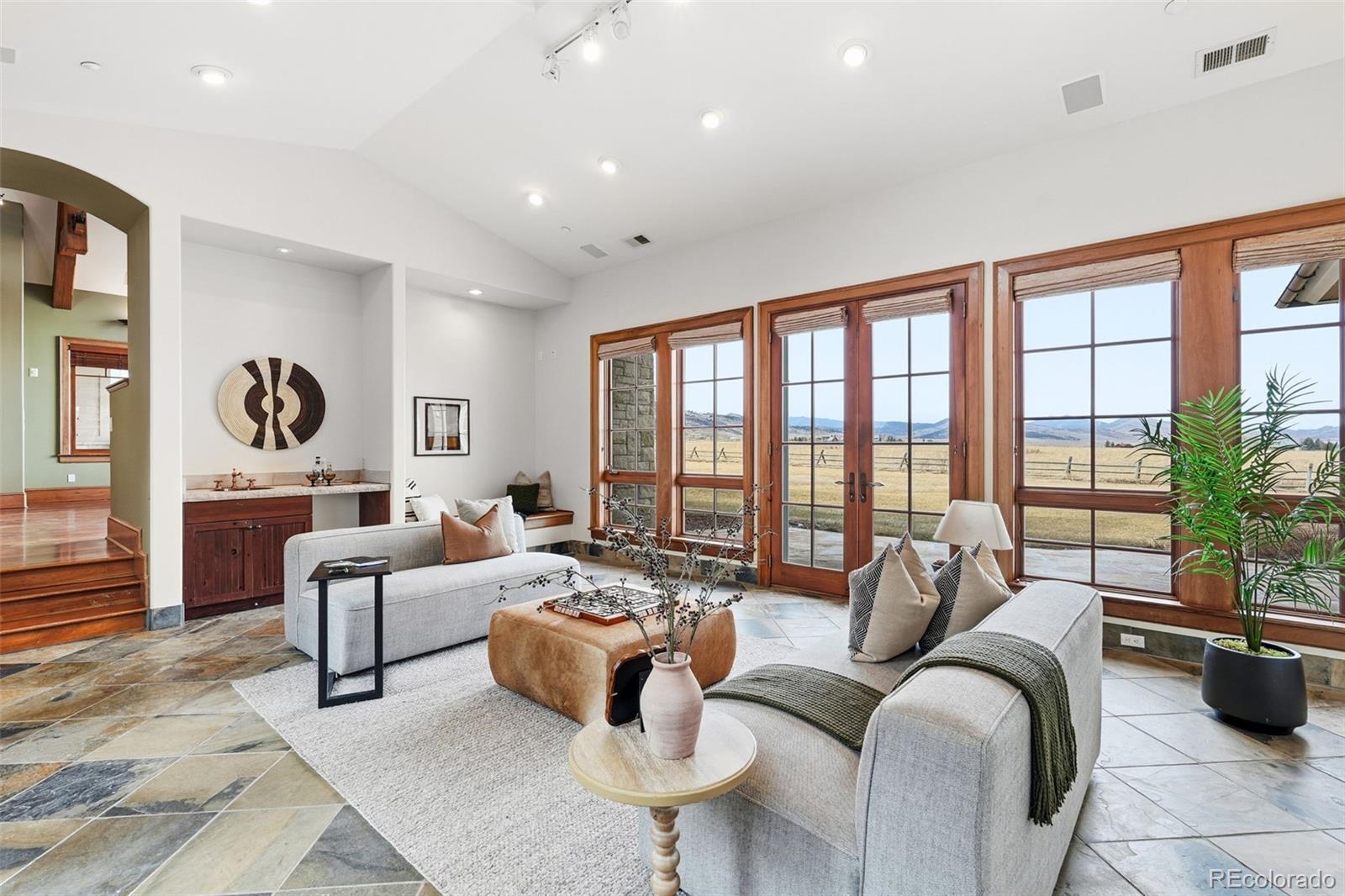 5101 St Vrain Road Longmont, CO 80503 - Photo 25 of 49 a living room with furniture and floor to ceiling windows