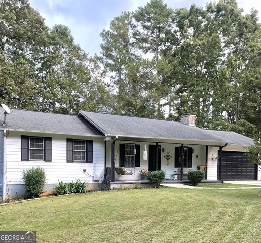 a front view of a house with a garden and porch