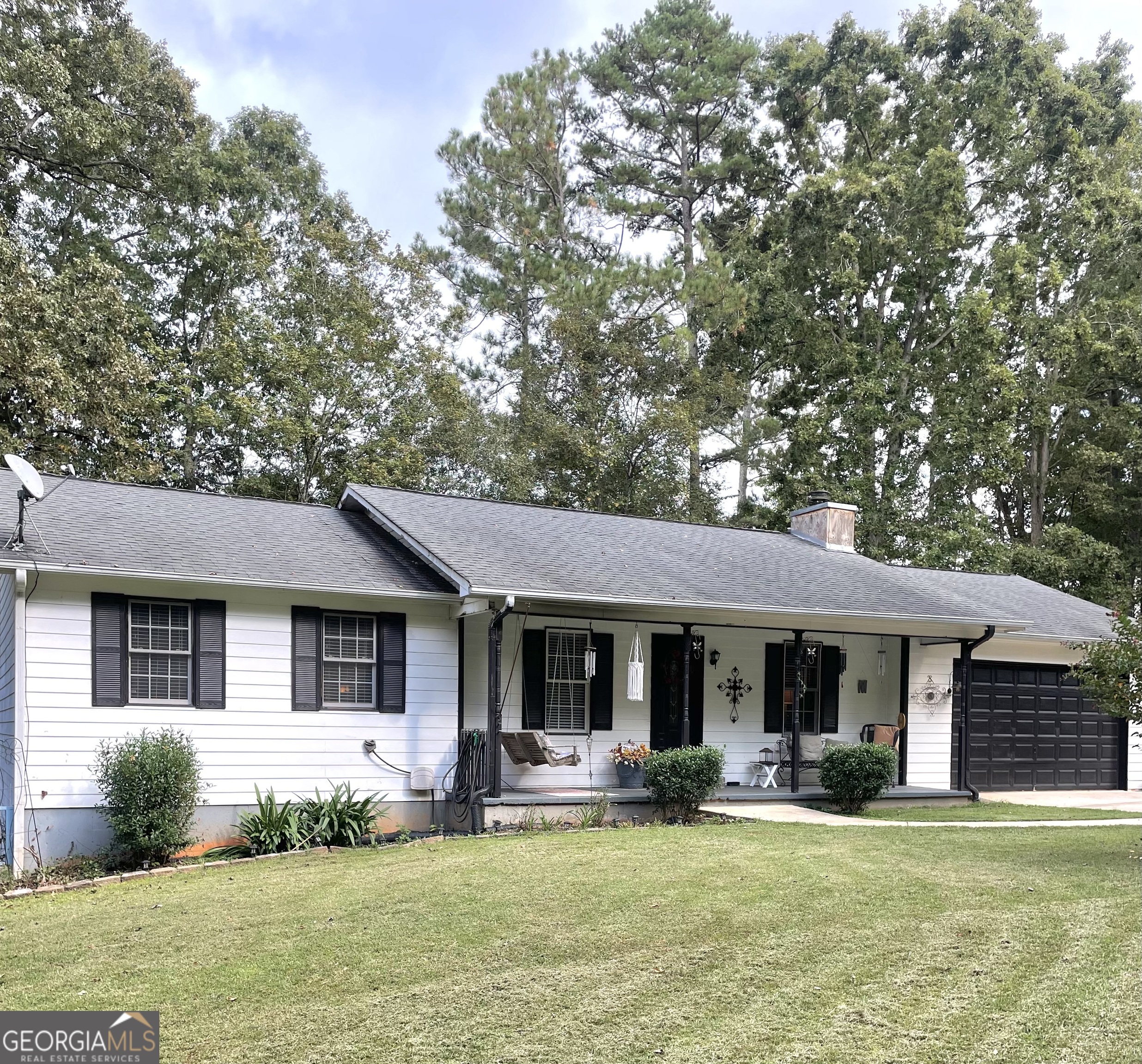 a front view of a house with a garden and porch