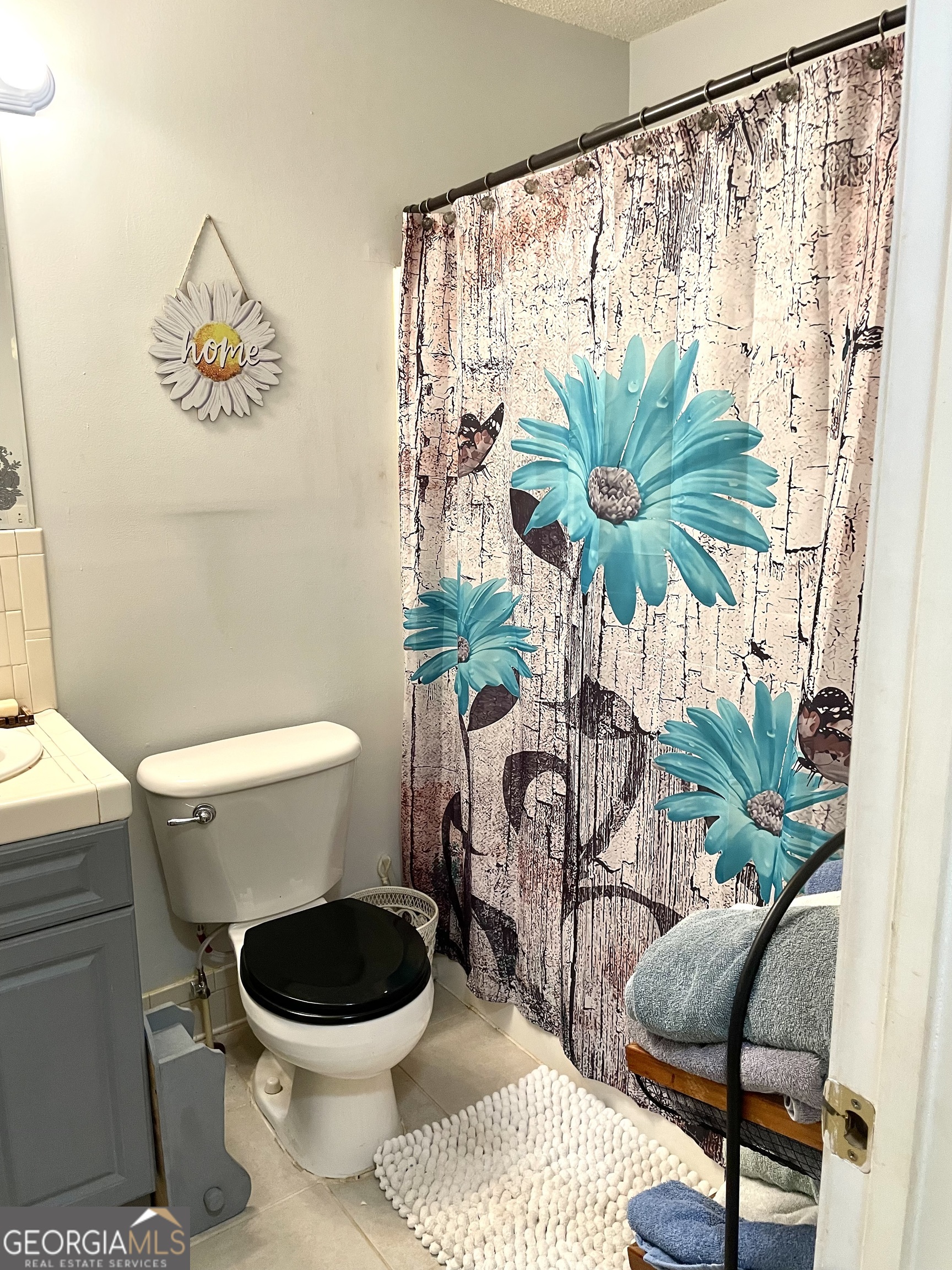 3010 Turner Church Road McDonough, GA 30252 - Photo 18 of 27 a bathroom with a toilet and a shower curtain