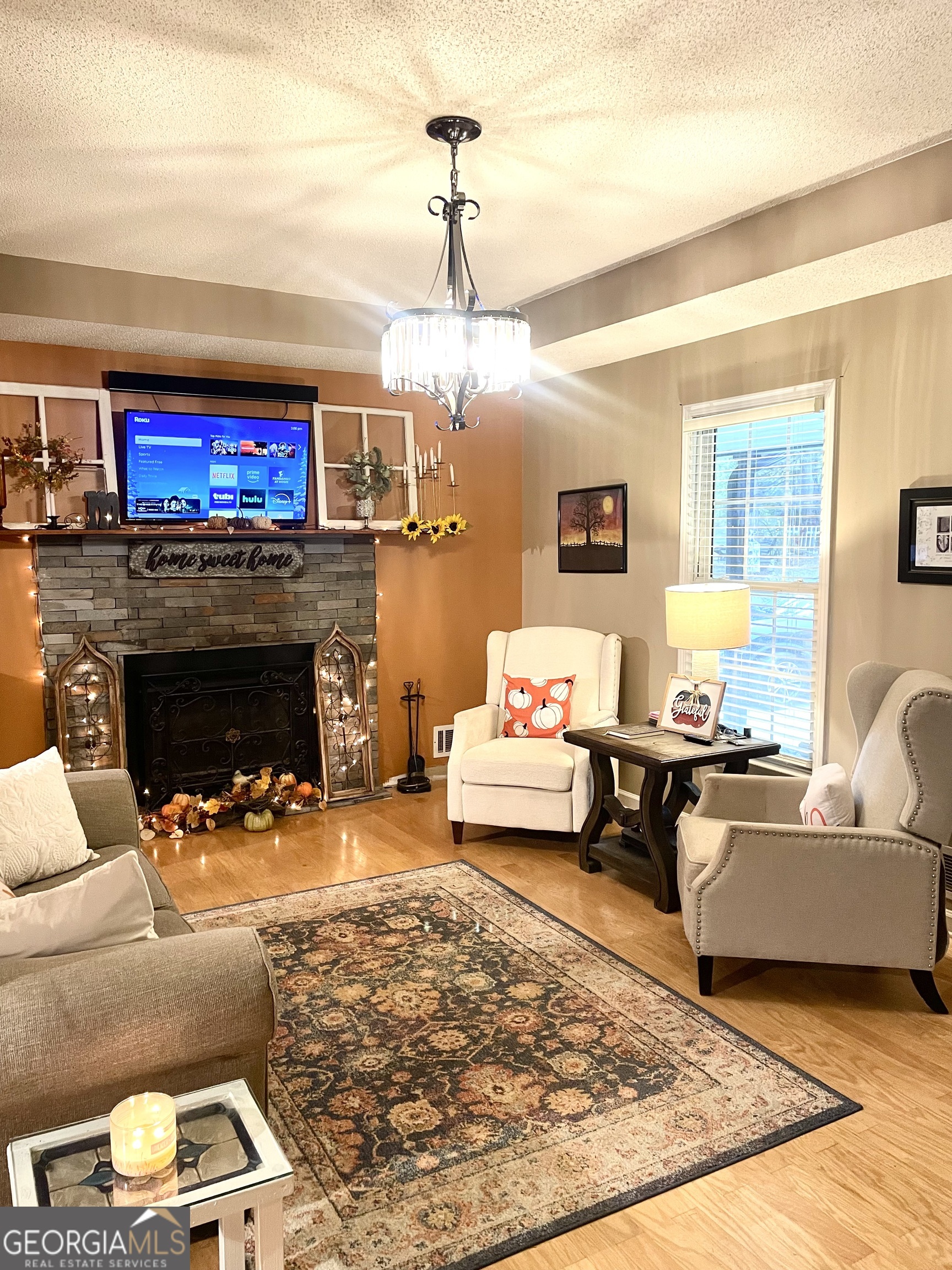 3010 Turner Church Road McDonough, GA 30252 - Photo 3 of 27 a living room with furniture a flat screen tv and a fireplace