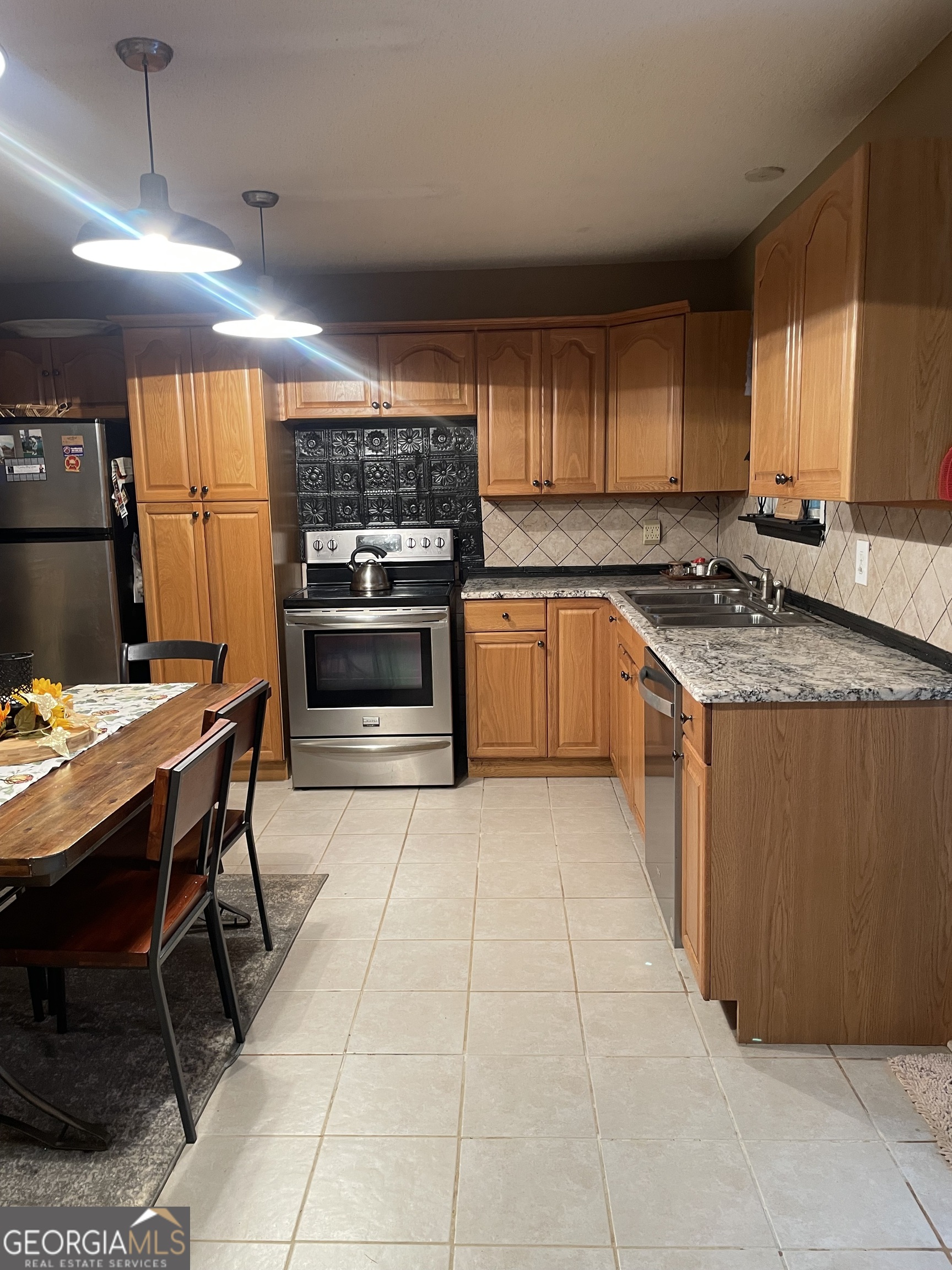 3010 Turner Church Road McDonough, GA 30252 - Photo 9 of 27 a kitchen with stainless steel appliances granite countertop a stove top oven a sink dishwasher and cabinets