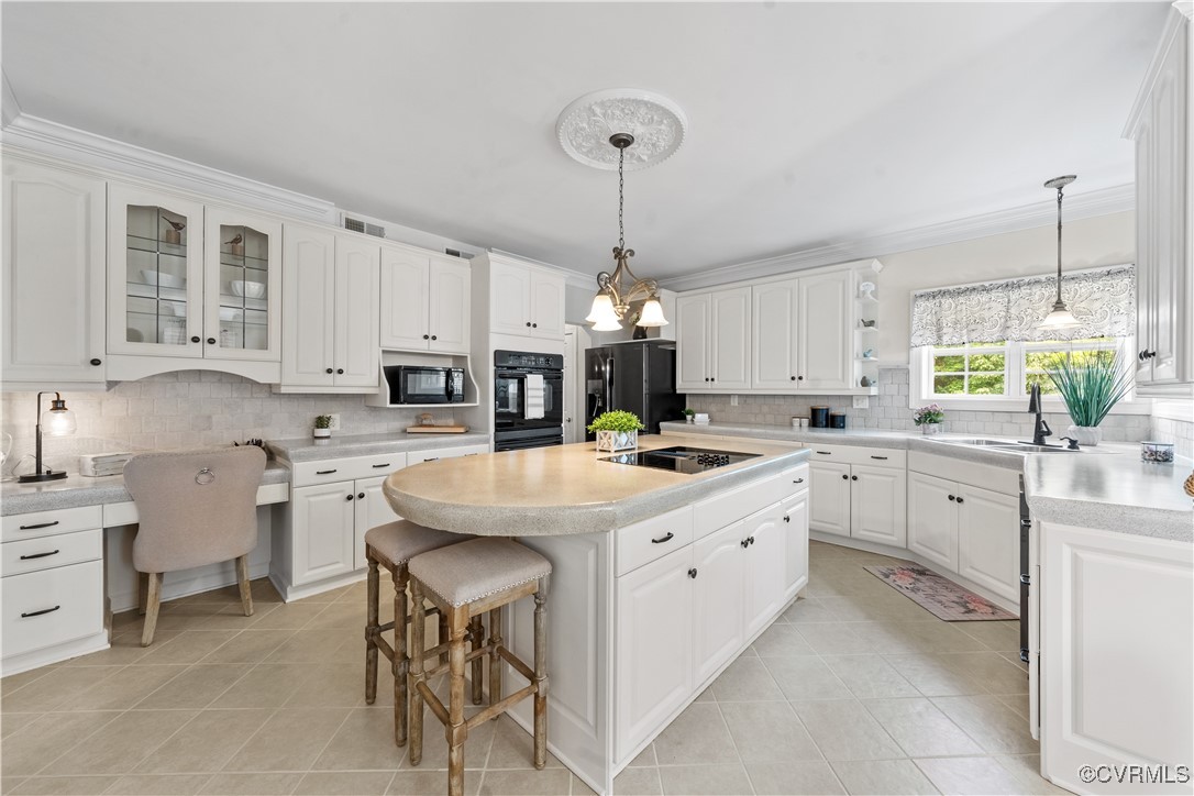 11936 Winterpock Road Chesterfield, VA 23838 - Photo 8 of 49 a kitchen with kitchen island granite countertop a sink a center island and cabinets