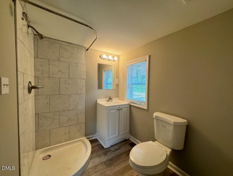 415 Spring Court Henderson, NC 27536 - Photo 7 of 7 a bathroom with a granite countertop toilet sink and shower