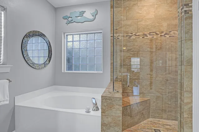 a bathroom with a granite countertop sink a mirror and a shower