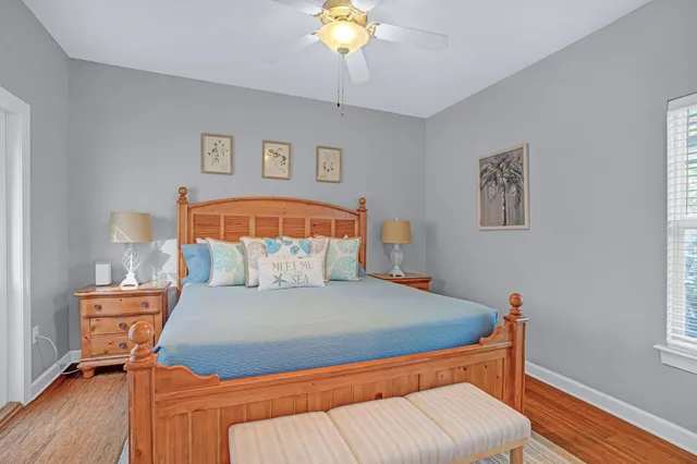 a bedroom with a bed and a lamp on dresser