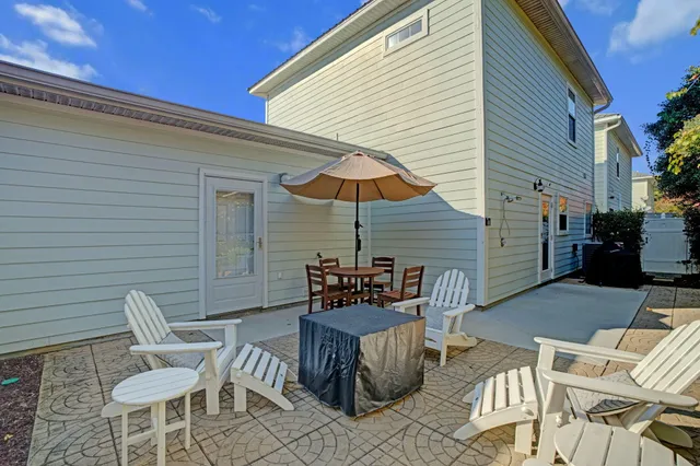 a view of backyard with seating space and trees