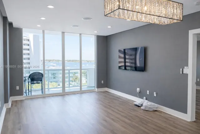 a view of room with window and wooden floor