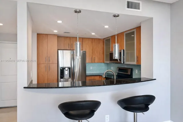 a kitchen with a refrigerator stove and microwave