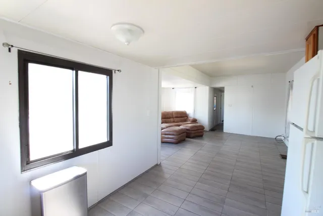a kitchen with stainless steel appliances a refrigerator and a wooden floor
