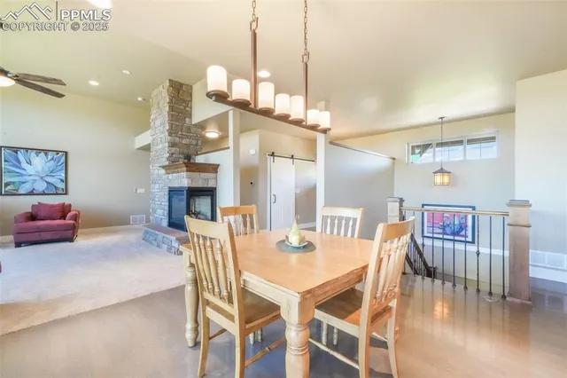 a dining room with furniture and wooden floor