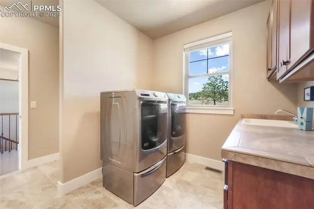 a utility room with sink dryer and washer