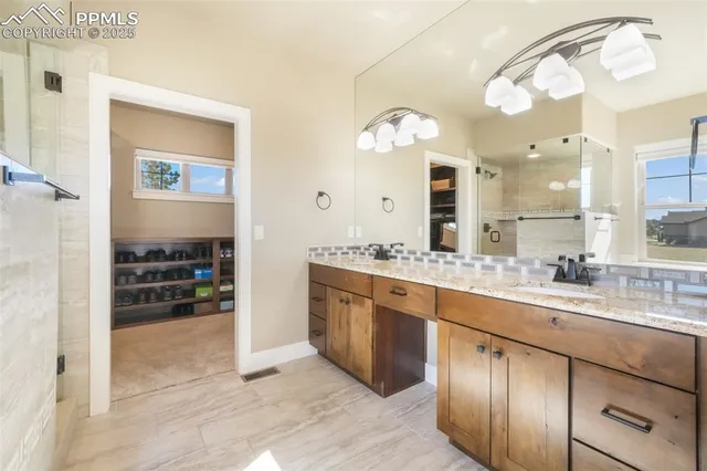 a spacious bathroom with a double vanity sink and a mirror