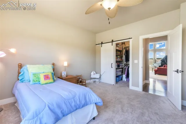 a bedroom with a large bed and a chandelier