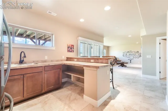 a kitchen with stainless steel appliances granite countertop a sink and cabinets