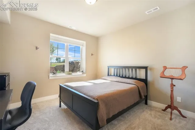 a bedroom with a bed chair and window