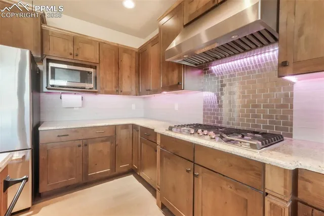 a kitchen with stainless steel appliances granite countertop a stove sink and cabinets