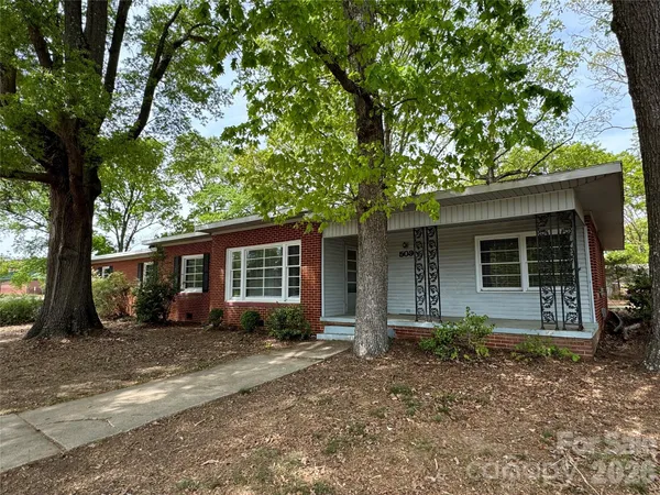 front view of a house with a tree in front of it