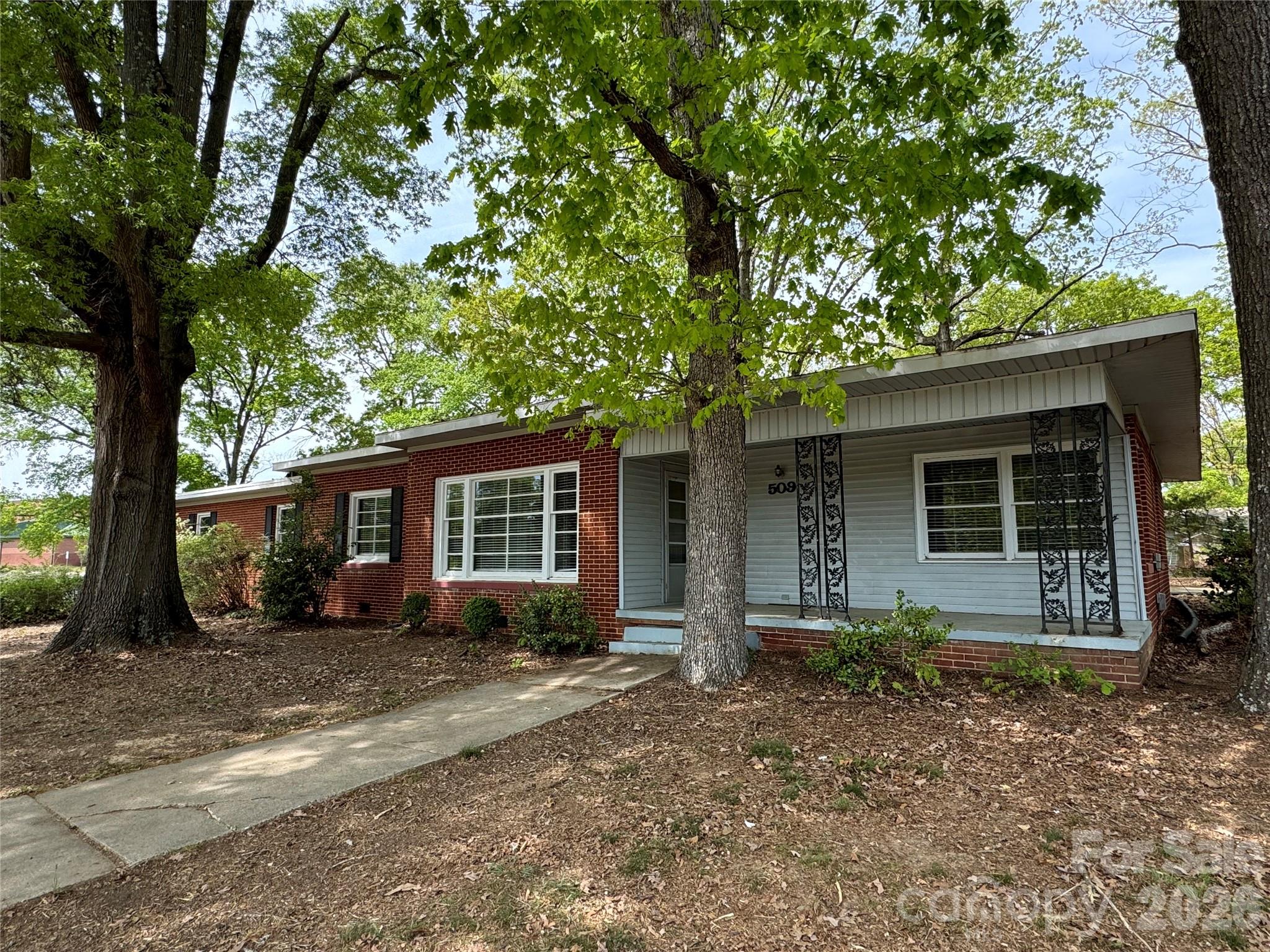 509 East Main Street Locust, NC 28097 - Photo 1 of 40 front view of a house with a tree in front of it