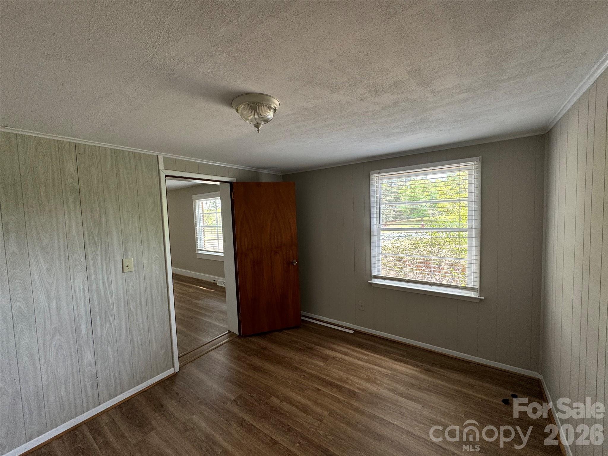 509 East Main Street Locust, NC 28097 - Photo 19 of 40 a view of an empty room with wooden floor and a window