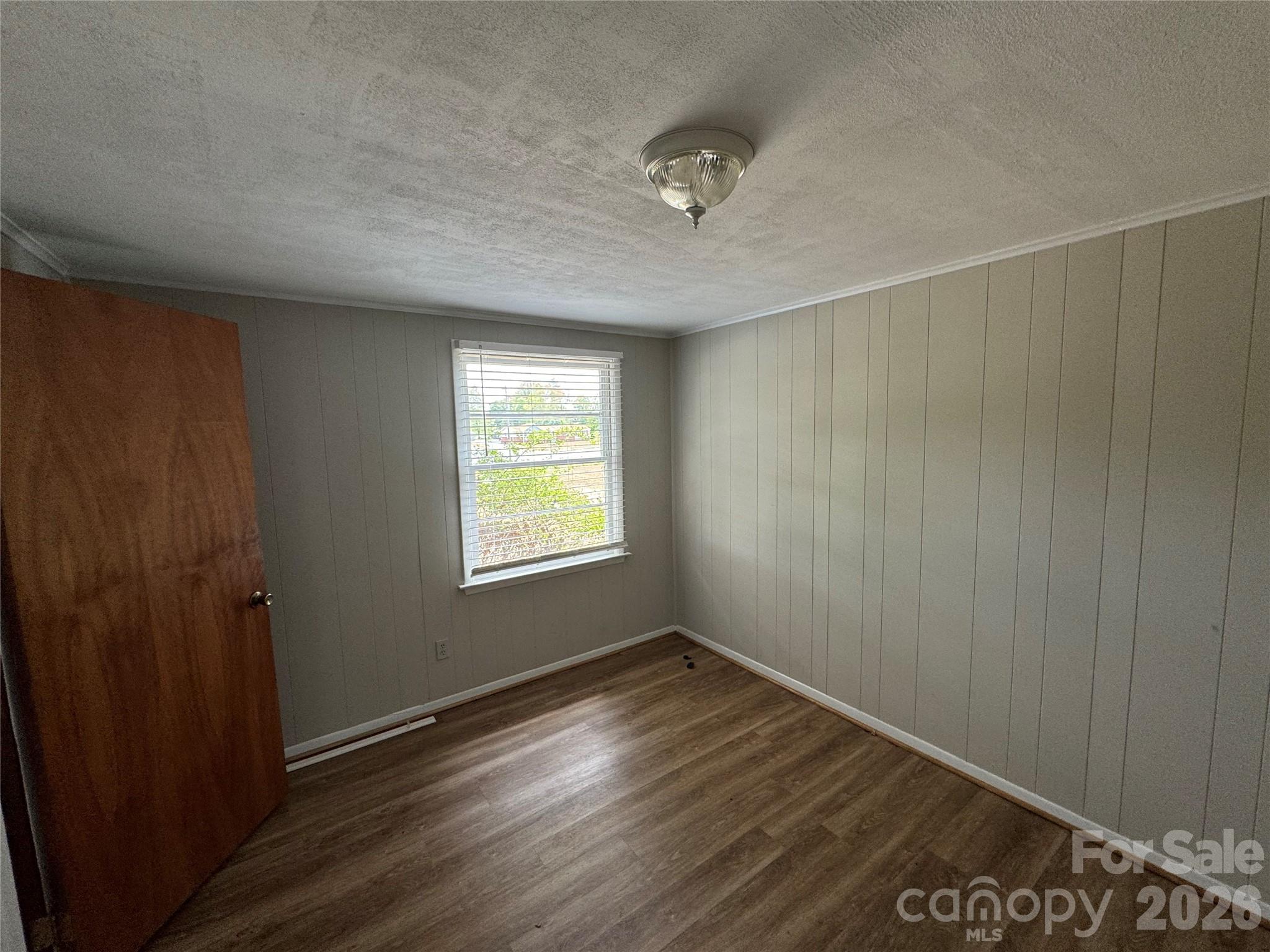 509 East Main Street Locust, NC 28097 - Photo 20 of 40 a view of an empty room with wooden floor and a window