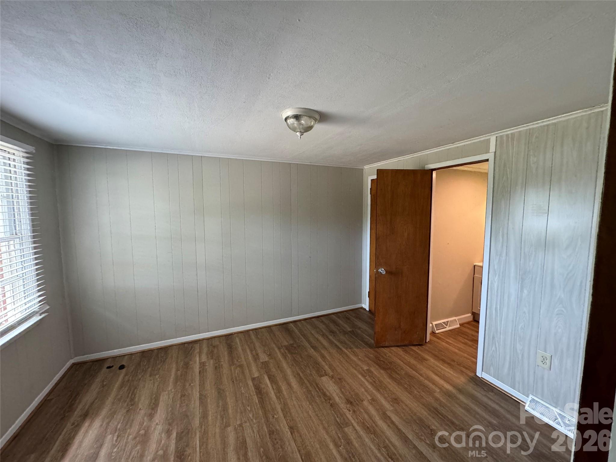 509 East Main Street Locust, NC 28097 - Photo 23 of 40 an empty room with wooden floor and windows