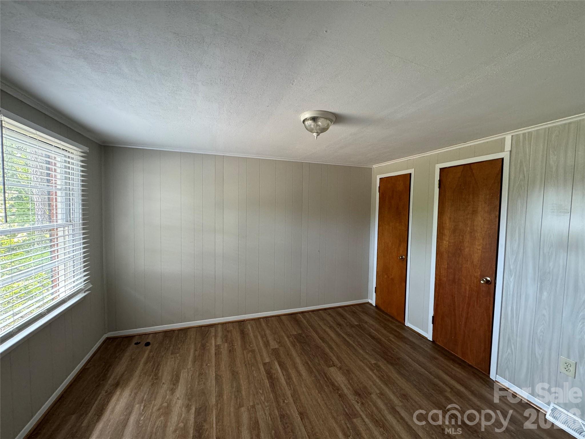 509 East Main Street Locust, NC 28097 - Photo 24 of 40 an empty room with wooden floor and windows