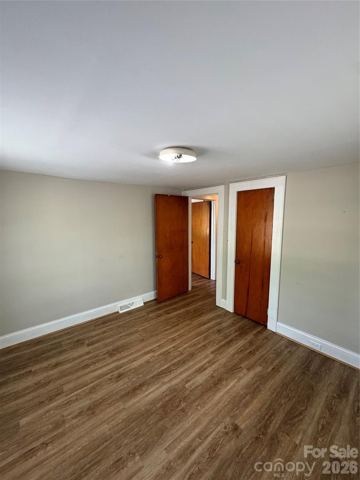 509 East Main Street Locust, NC 28097 - Photo 27 of 40 a view of an empty room with wooden floor and window