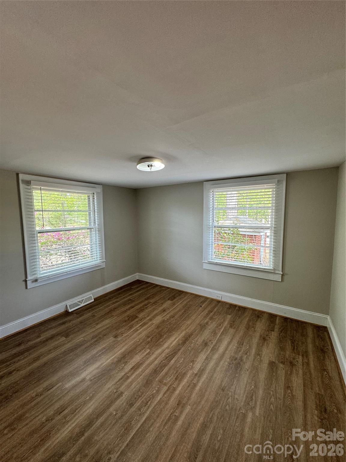 509 East Main Street Locust, NC 28097 - Photo 28 of 40 an empty room with wooden floor and windows