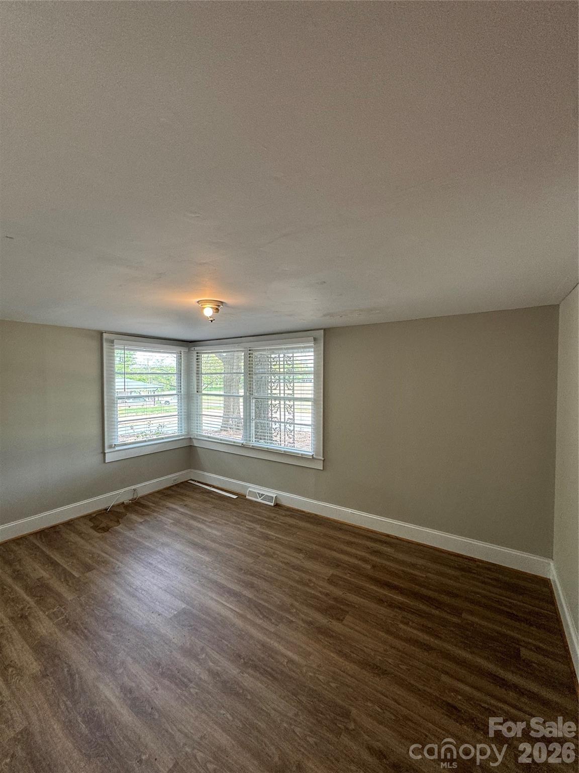 509 East Main Street Locust, NC 28097 - Photo 30 of 40 a view of an empty room with wooden floor and a window
