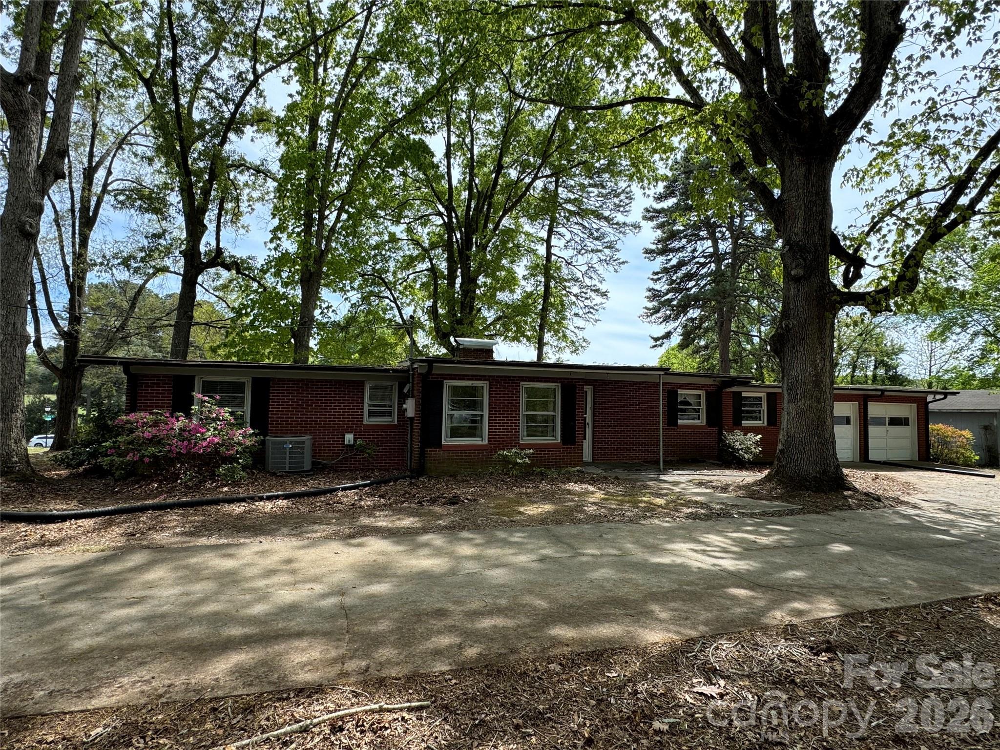 509 East Main Street Locust, NC 28097 - Photo 35 of 40 a view of a house with a yard and large trees