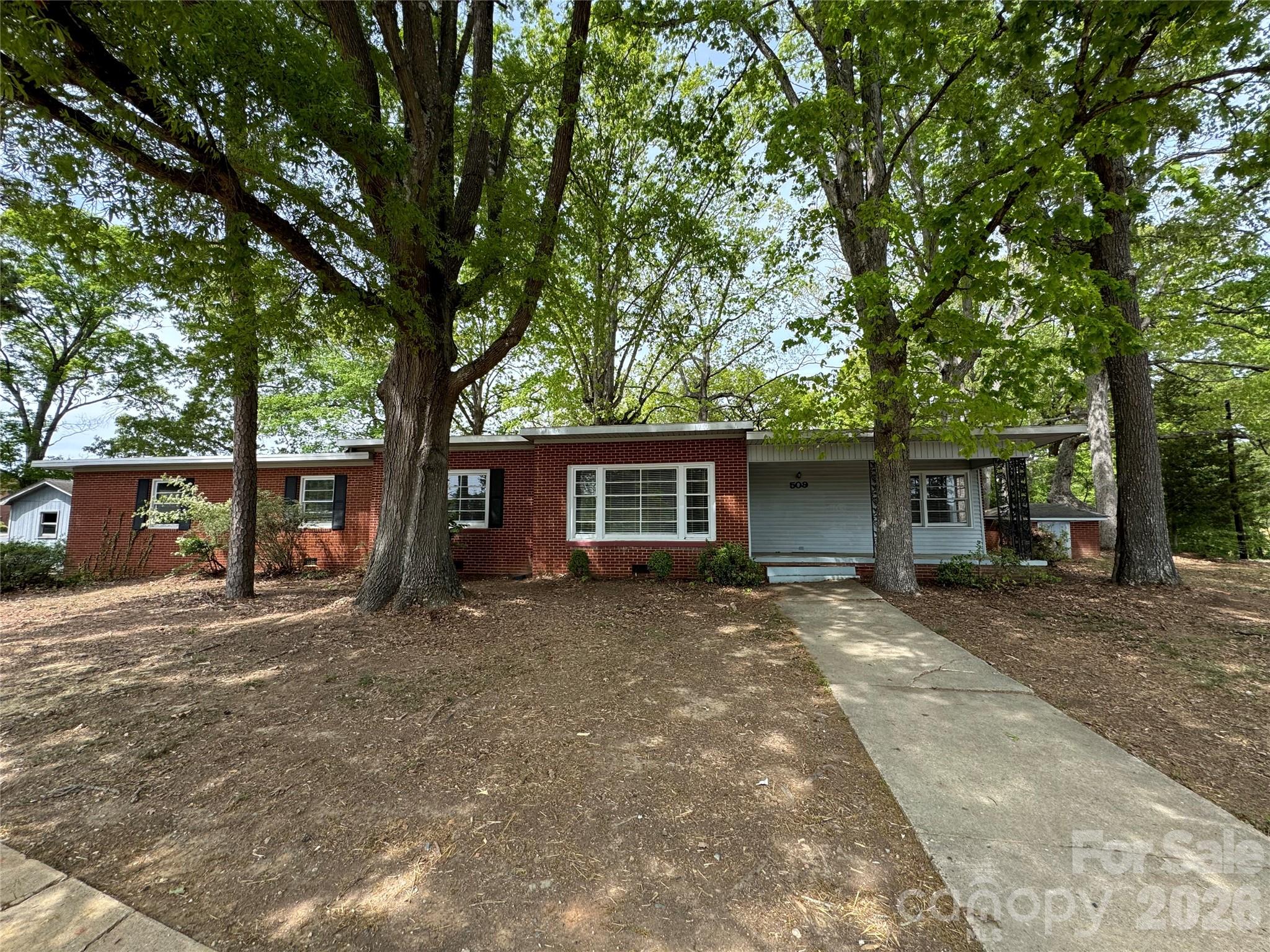 509 East Main Street Locust, NC 28097 - Photo 40 of 40 a view of a house with a yard and large tree